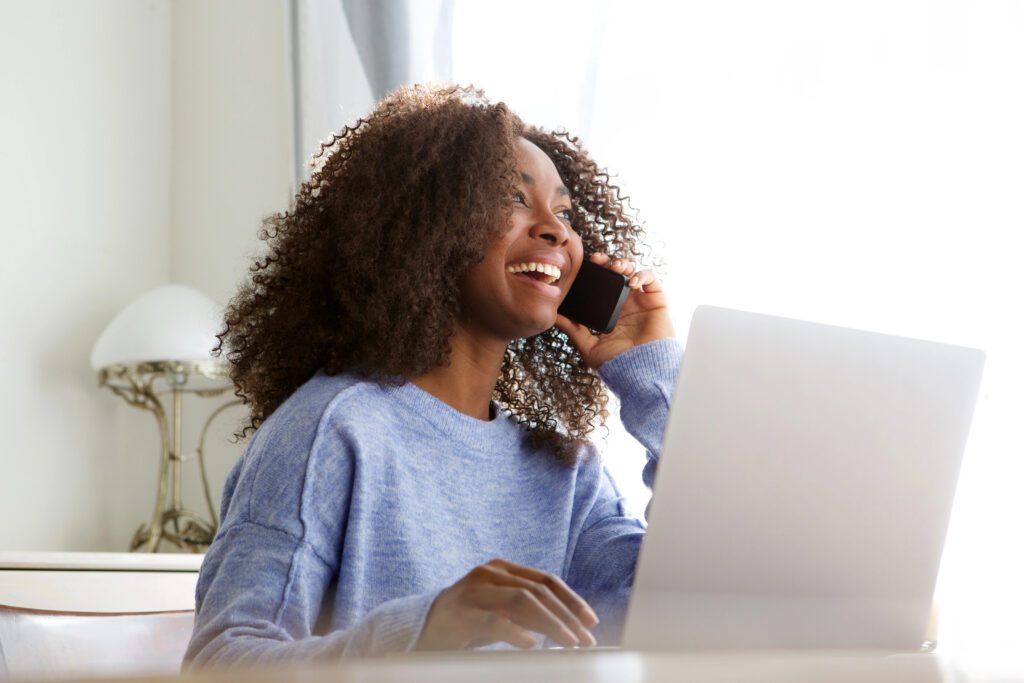 Woman talking about brand development on her phone in office